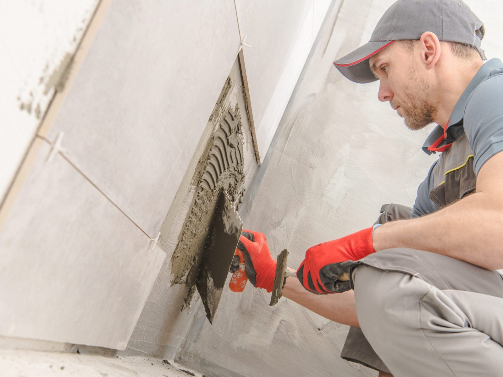 Bathroom Ceramic Tiles Installer. Caucasian Construction Worker in His 30s.
